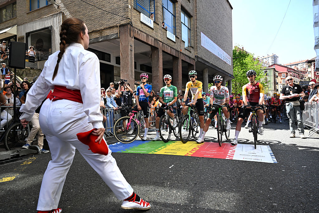 EIBAR, SPAIN - APRIL 10: (L-R) Markel Beloki of Spain and Team EF Education - EasyPost - Blue Best Young Rider Jersey, Igor Arrieta of Spain and UAE Team Emirates - XRG - Green Points Jersey, Paul Seixas of France and Team Decathlon CMA CGM - Yellow Leader Jersey, Joan Bou of Spain and Team Caja Rural - Seguros RGA - Polka Dot Mountain Jersey and Alex Aranburu of Spain and Team Cofidis attend to an "Aurresku" (Basque traditional ceremonial dance) prior to the 65th Itzulia Basque Country 2026, Stage 5 a 176.2km stage from Eibar to Eibar / #UCIWT / on April 10, 2026 in Eibar, Spain. (Photo by Tim de Waele/Getty Images)
