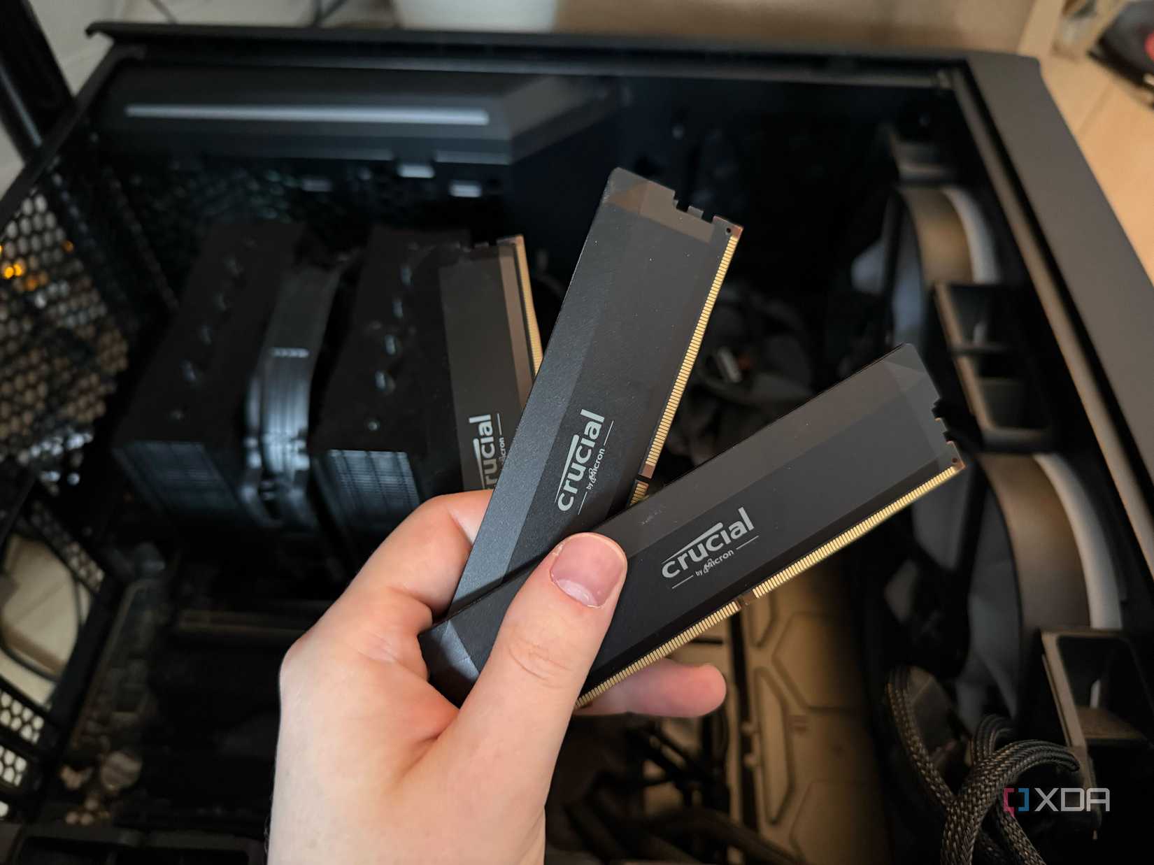A photo of someone holding 3 sticks of DDR5 RAM