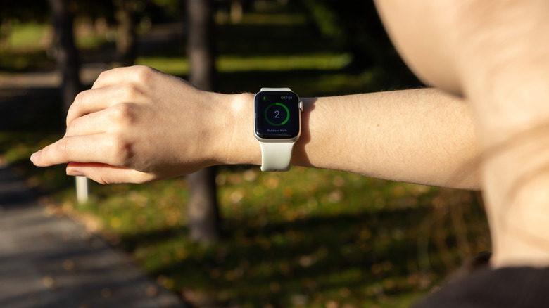 A person wearing the Apple Watch outdoors.