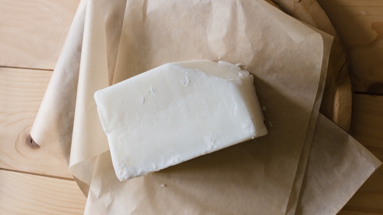 Beef tallow on culinary paper and wooden surface