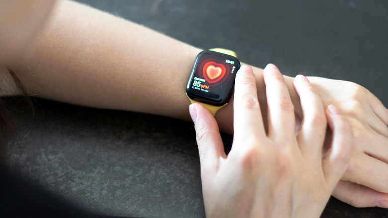 Close-up of person checking health information on Apple Watch