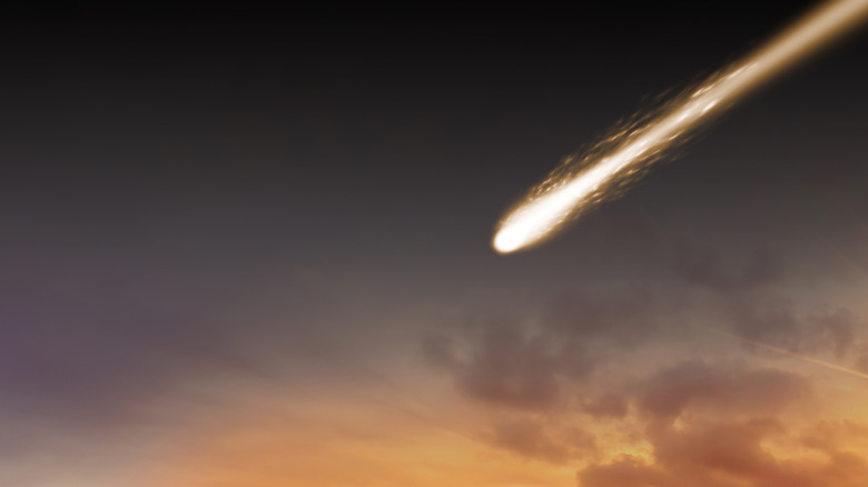 Meteor falling to surface at sunset