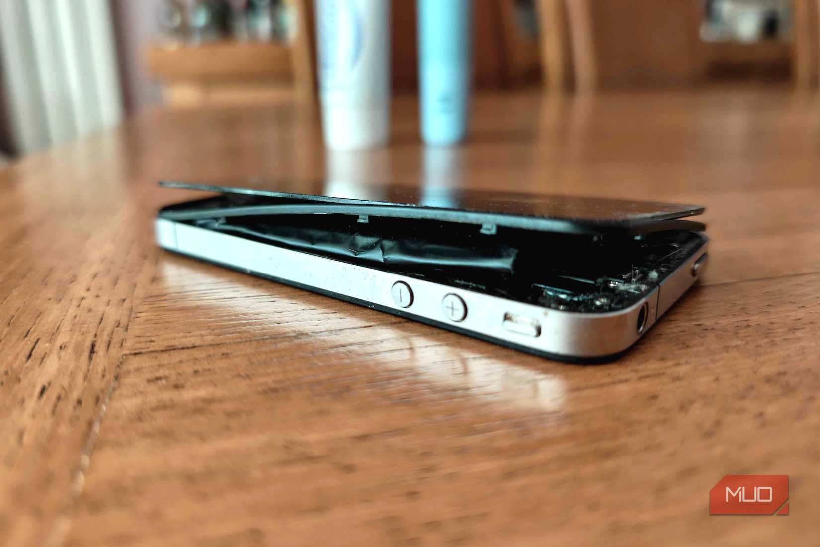 iphone 4 swollen battery on table.