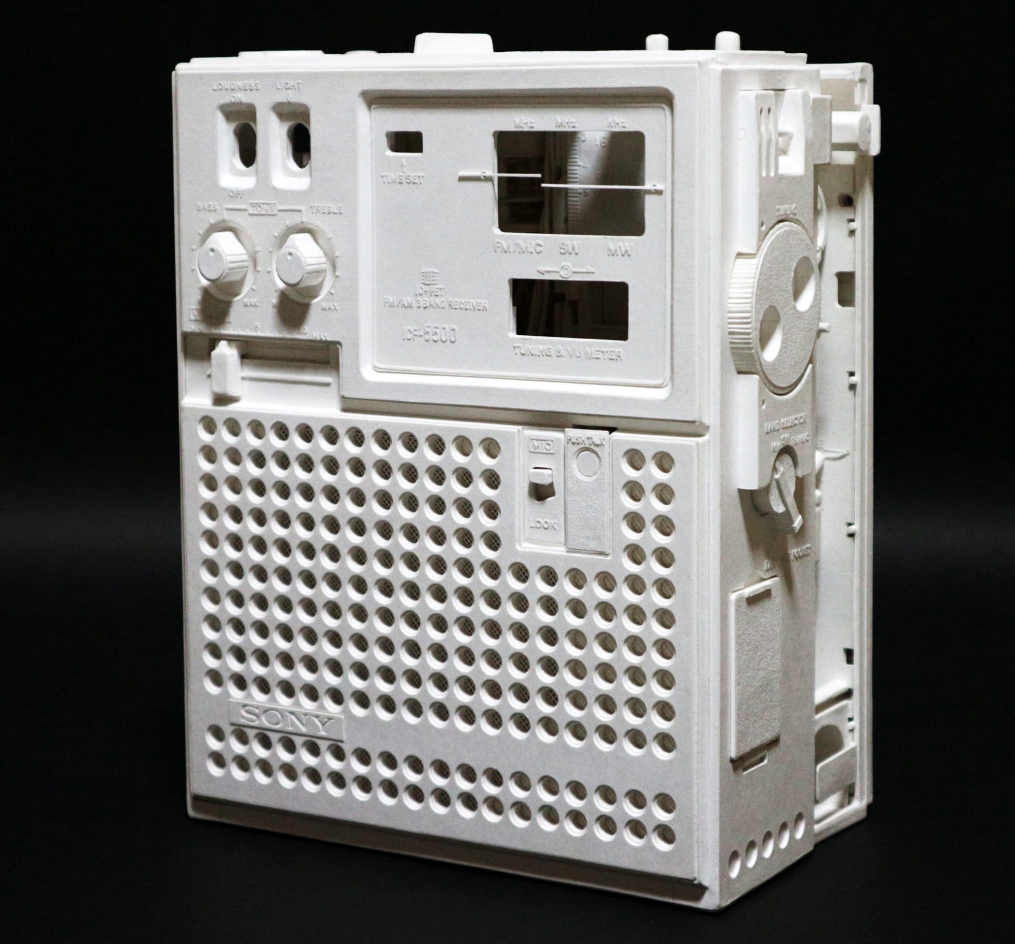 a hyperrealistic, scale sculpture of a small radio made from white paper
