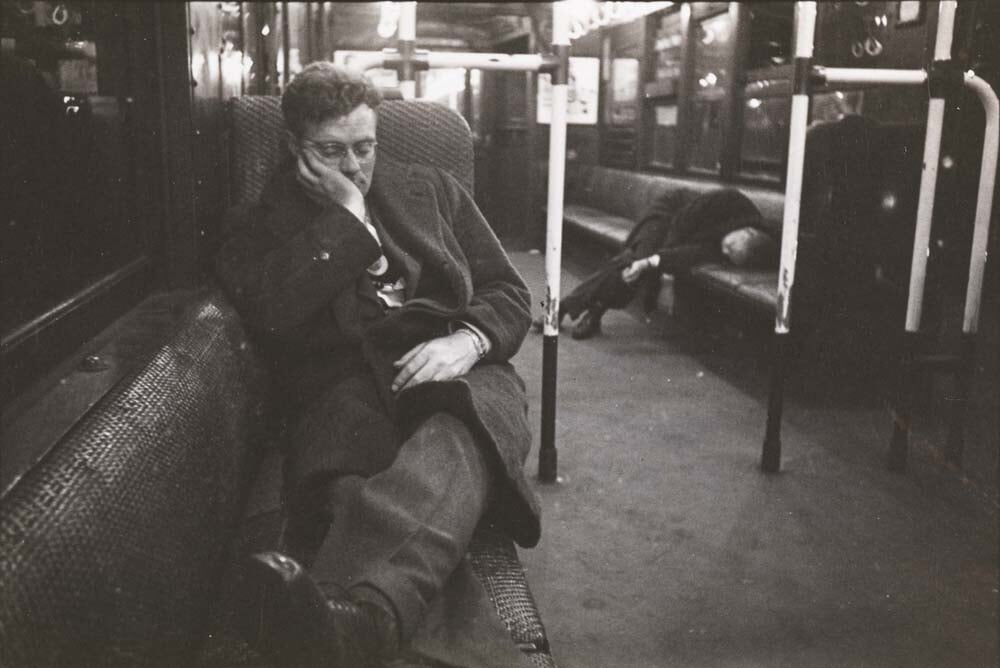 Black and white photograph of two men sleeping and/or passed out on a subway car in New York, 1945.
