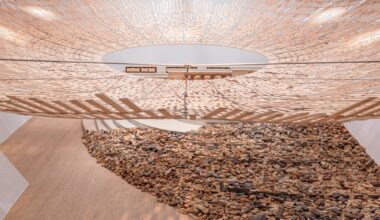 light streams through a wooden canopy in a large scale installation of wood and brick by Kengo Kuma
