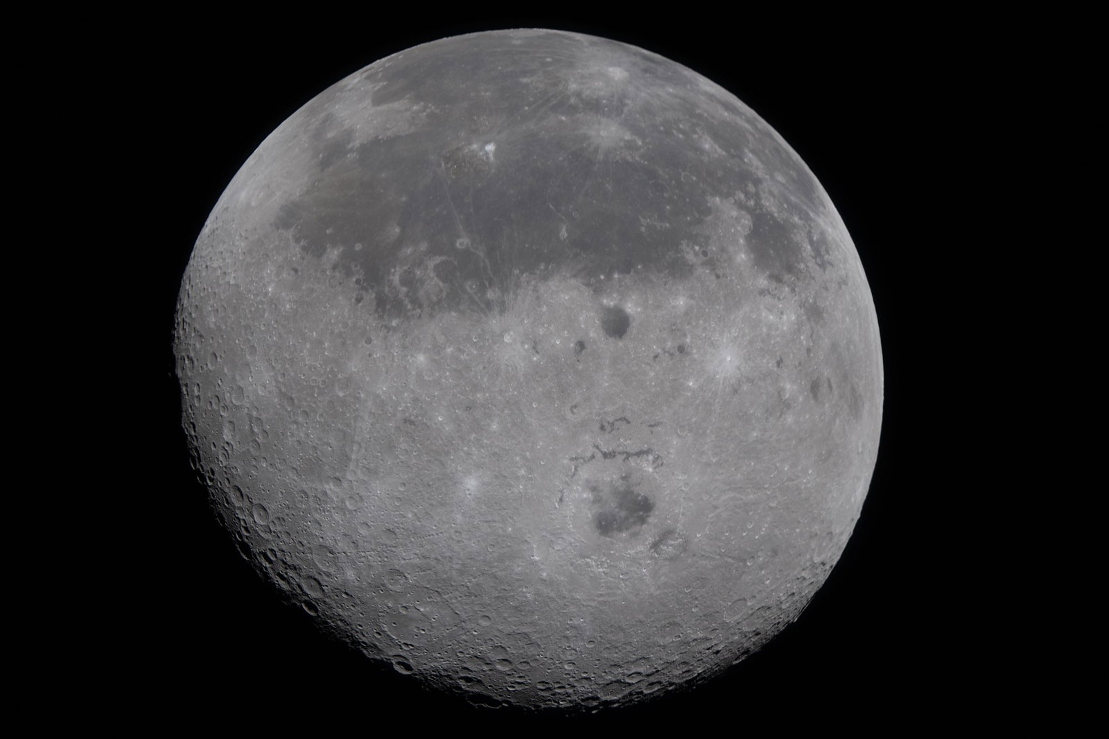 A clear image of the Moon showing craters and a textured grey surface.