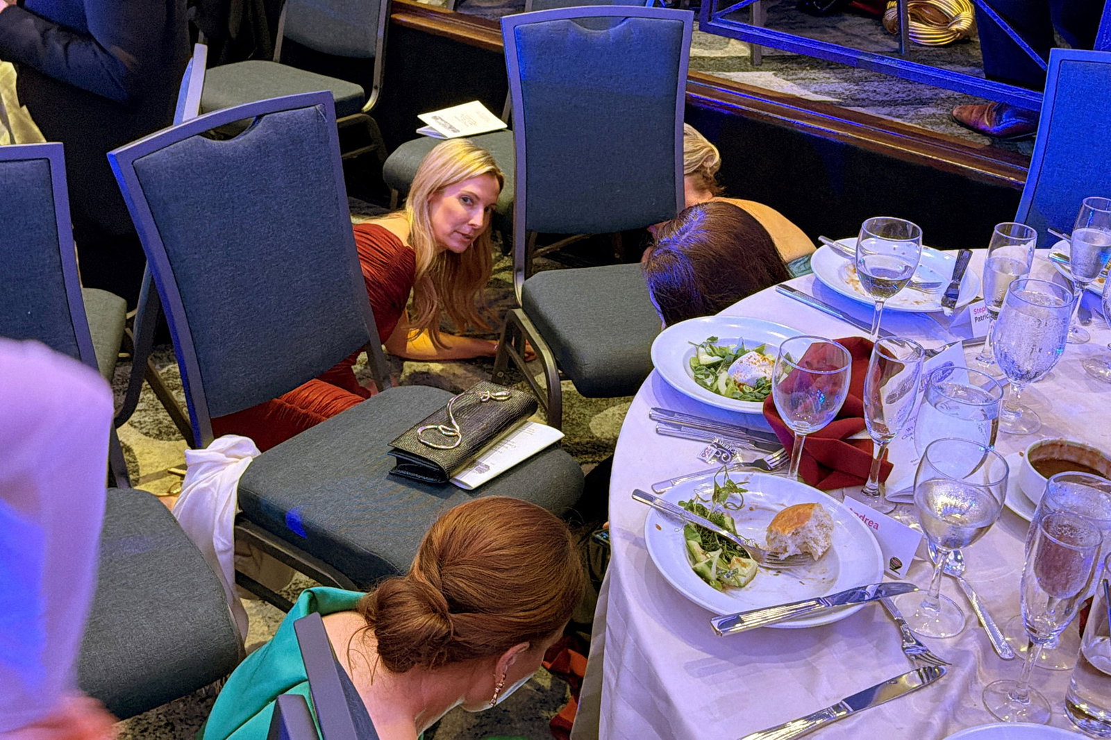 Guests hiding and lying down under tables.
