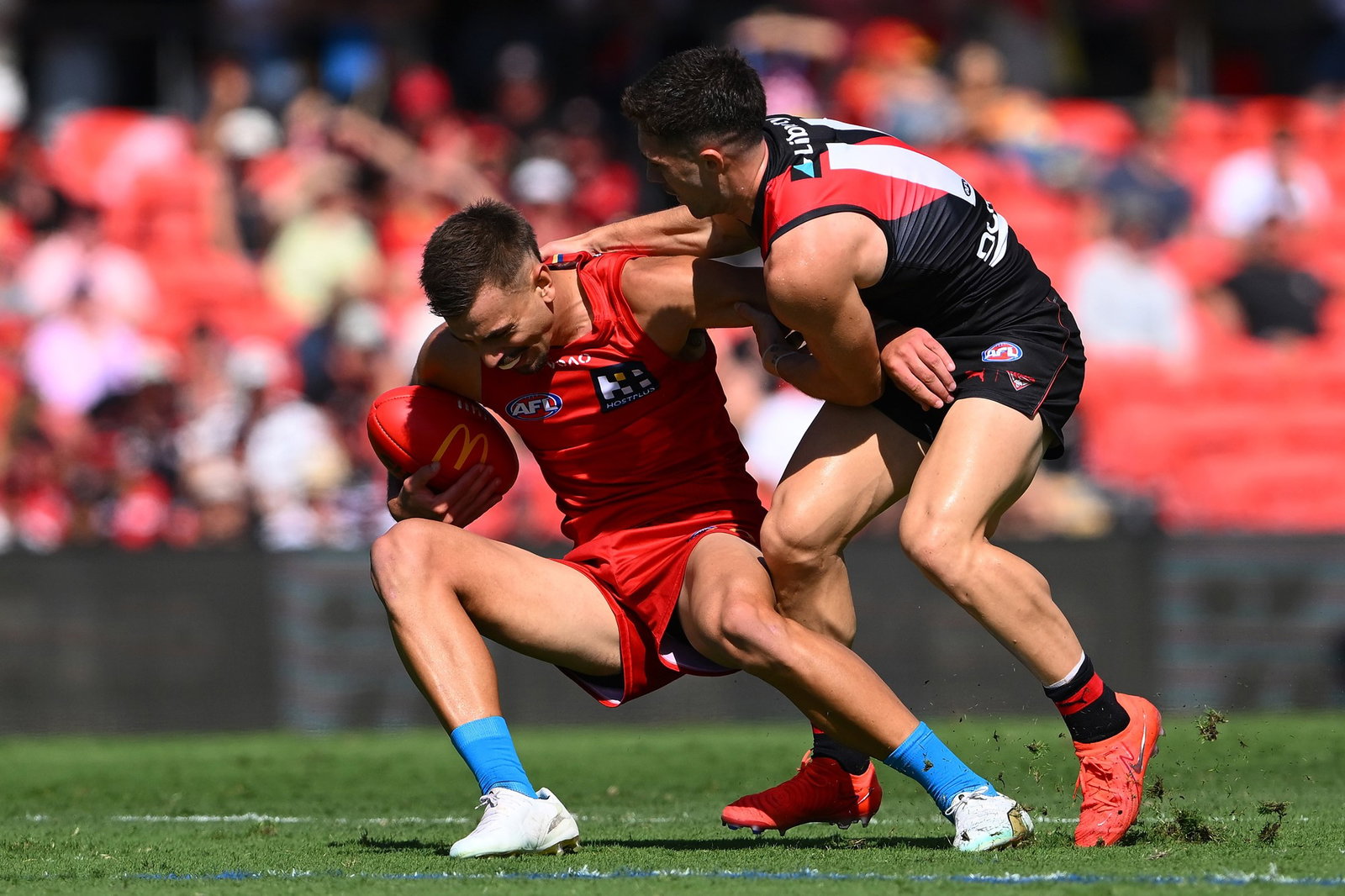 A Suns player tackled by a Bombers opponent.
