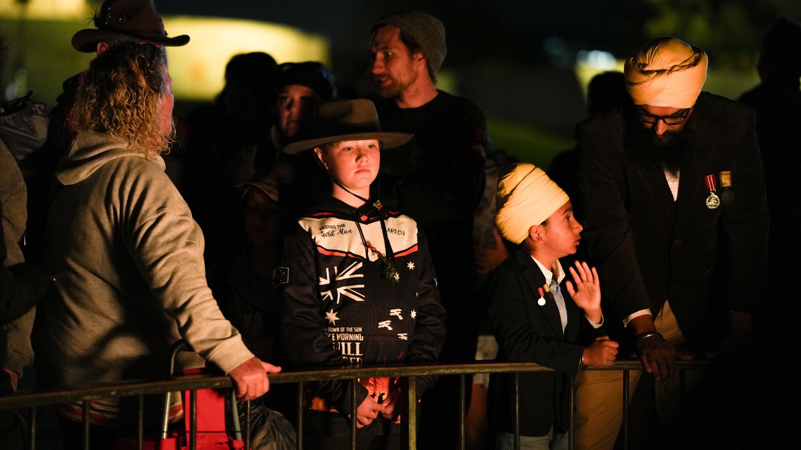 young children watch on during an anzac service