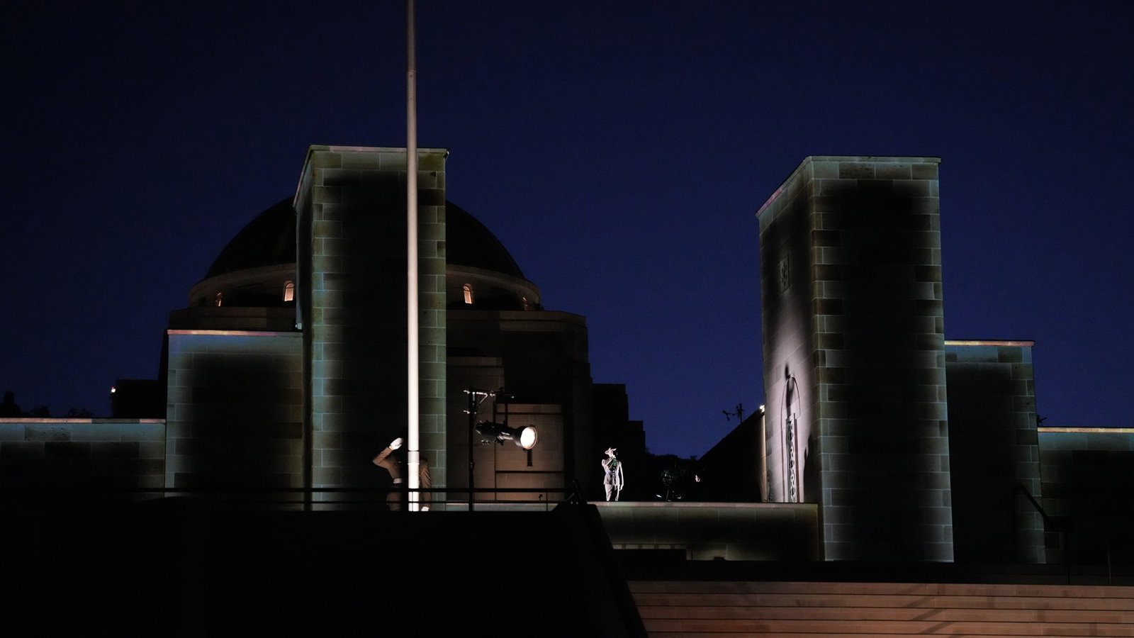 the australian war memorial before dawn, lights shine on the building