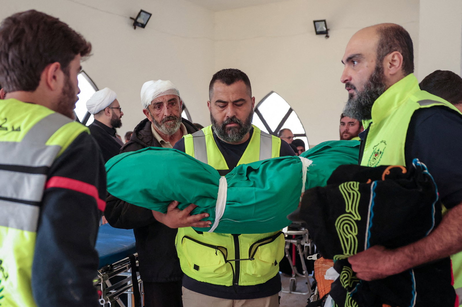 A member of civil defence personnel holds the body of Taleen Saeed, 1.5 years old, killed in an Israeli strike in the village of Srifa