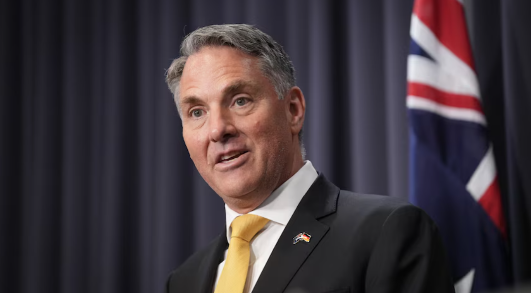 Richard Marles with the Aus flag behind him