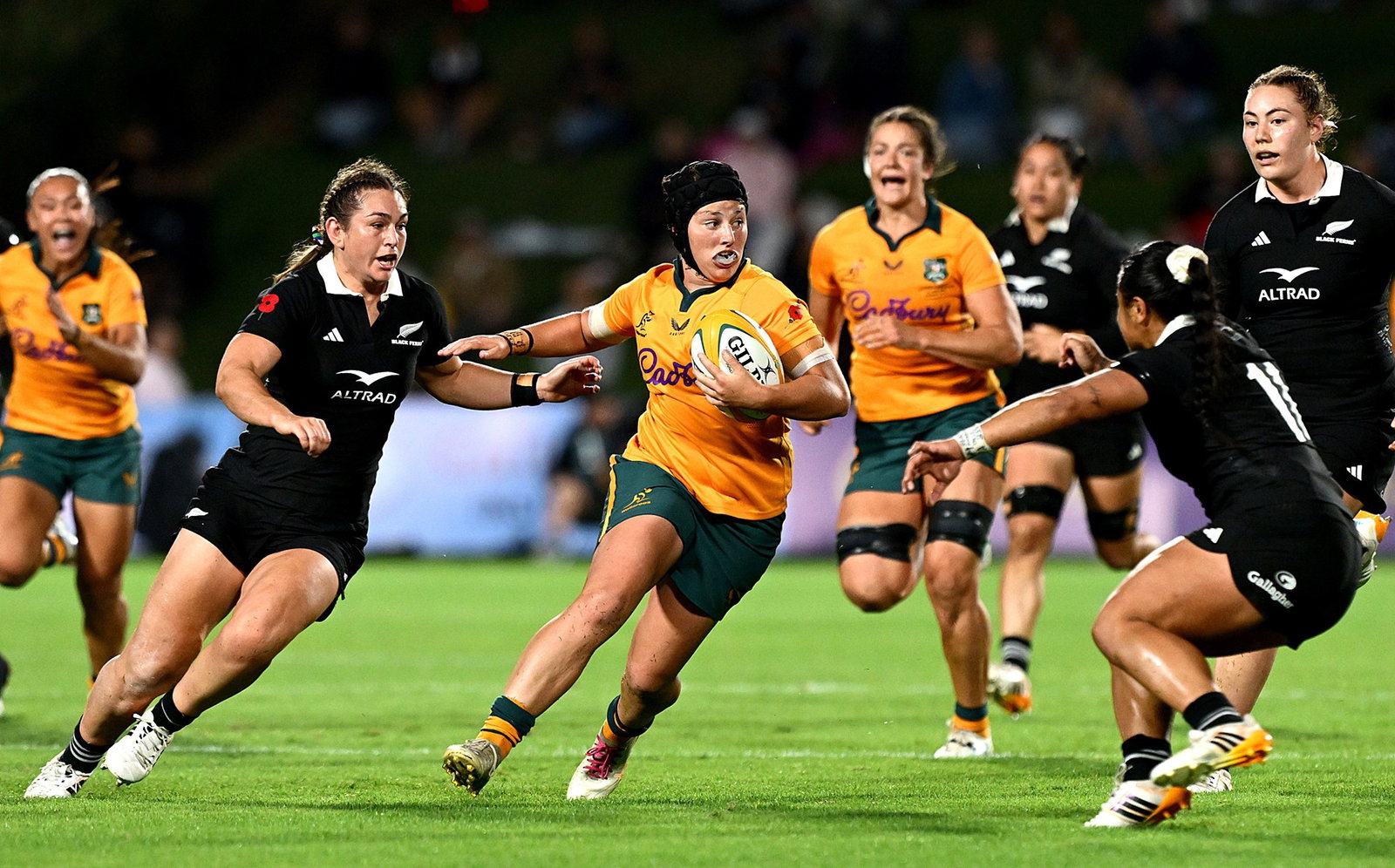 Wallaroos player makes a run against Black Ferns.