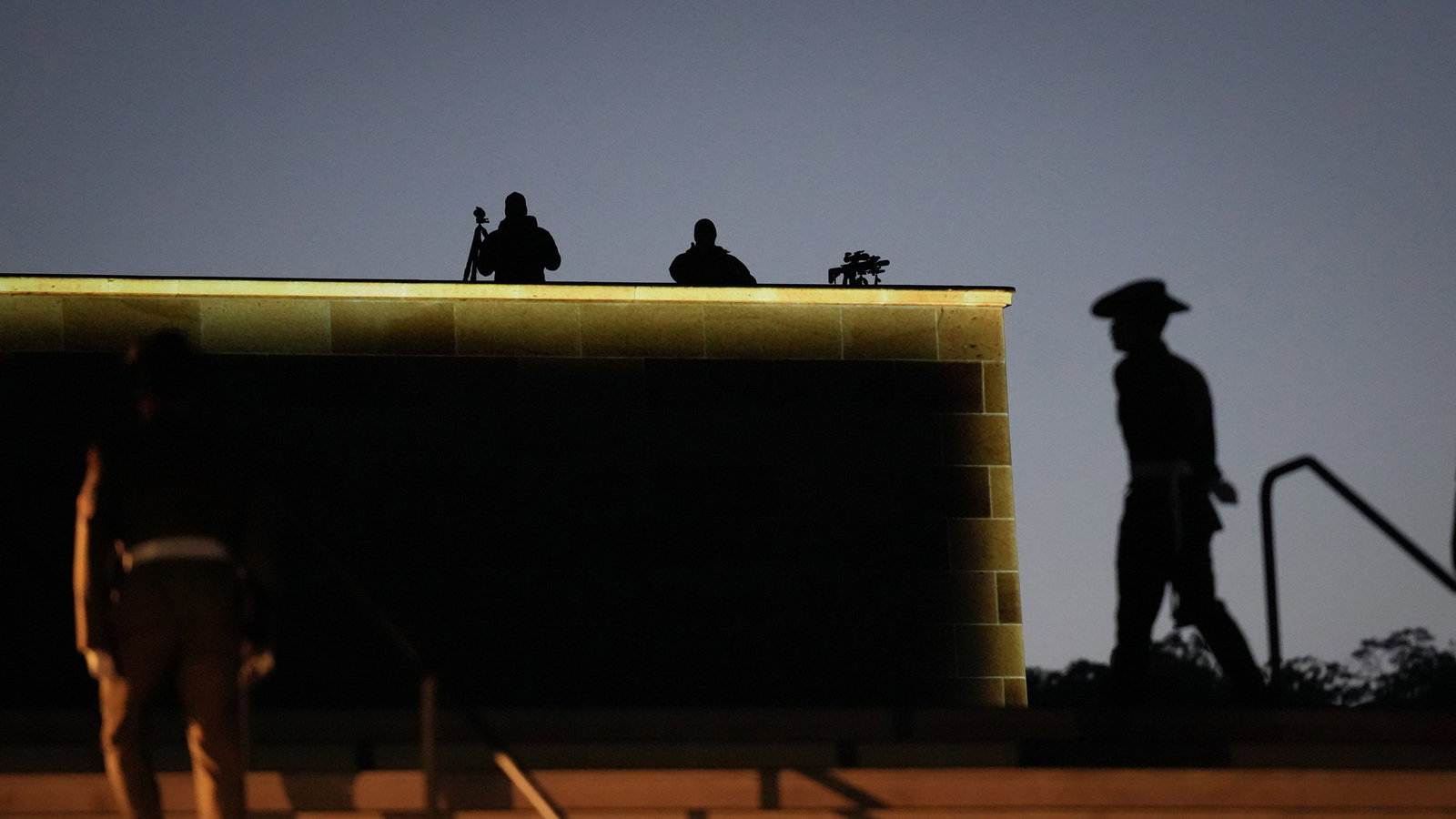 soldiers stand guard over a wall at the australian war memorial
