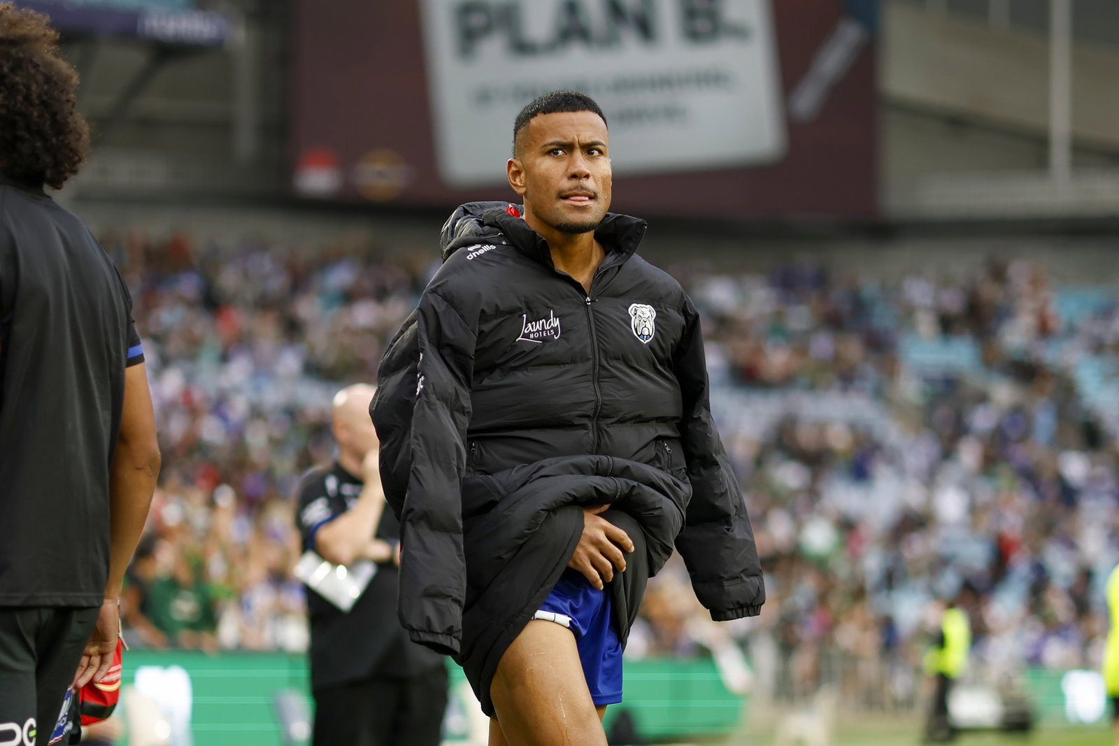 An injured Stephen Crichton of the Bulldogs walks on to the pitch 