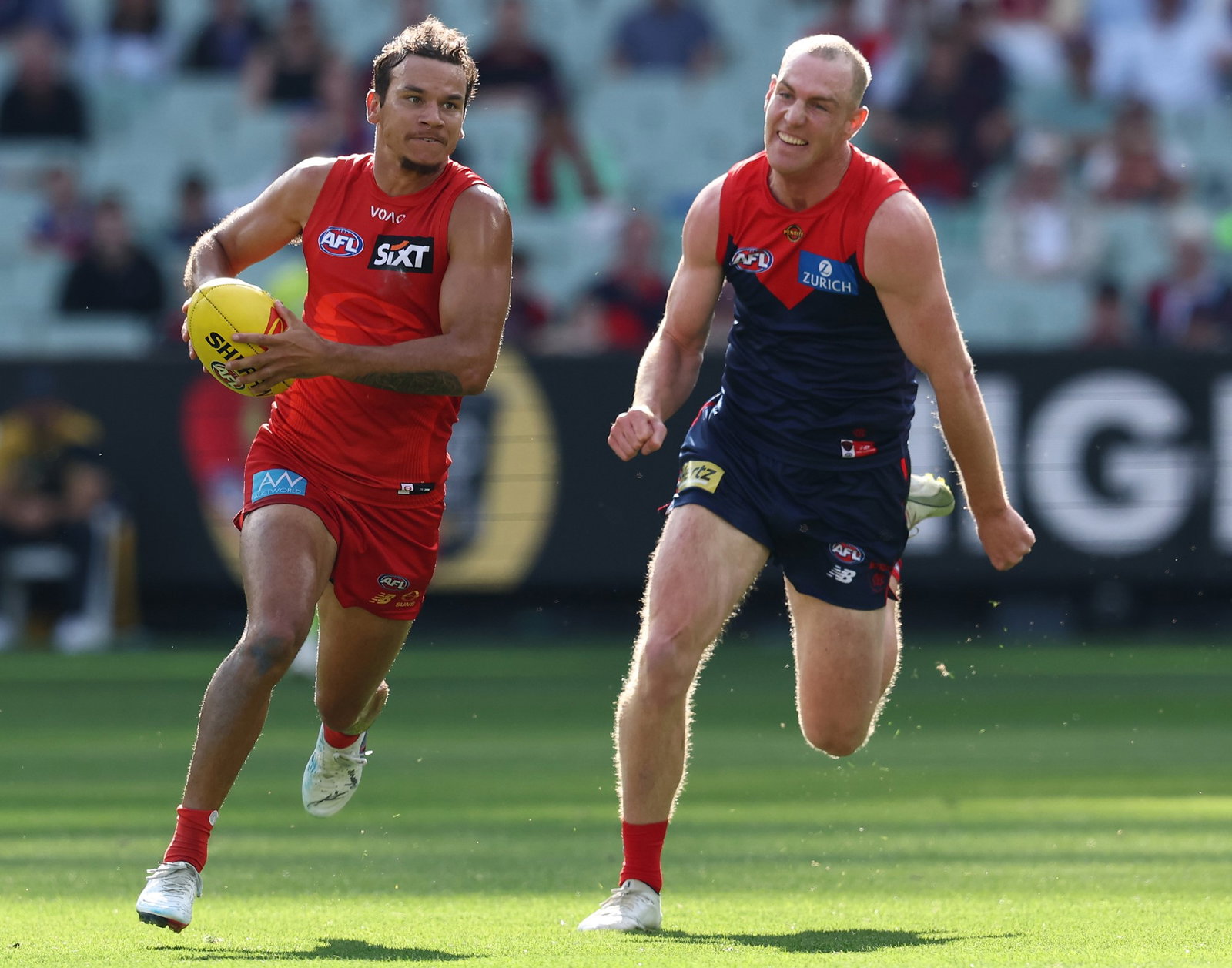 Daniel Rioli of the Suns runs with the ball during the 2026 AFL Round 04 match between the Melbourne Demons and the Gold Coast Suns at the Melbourne Cricket Ground on April 5, 2026 in Melbourne, Australia.
