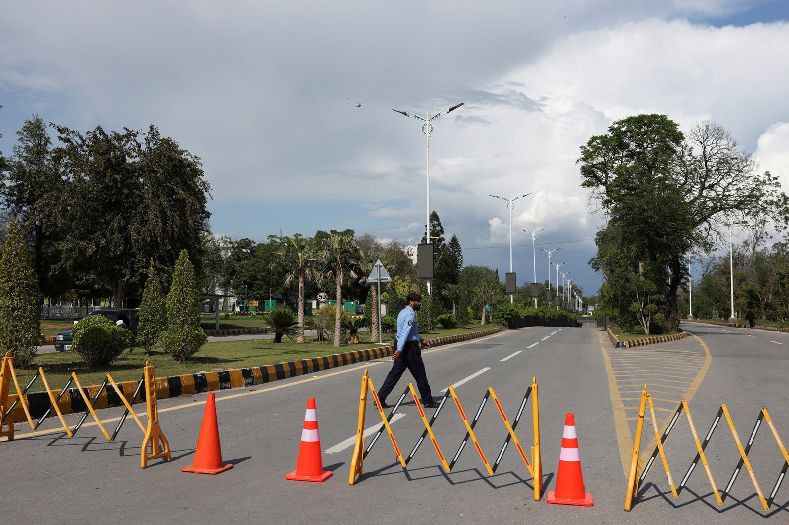 A police officer walks on the road, blocked for security measures