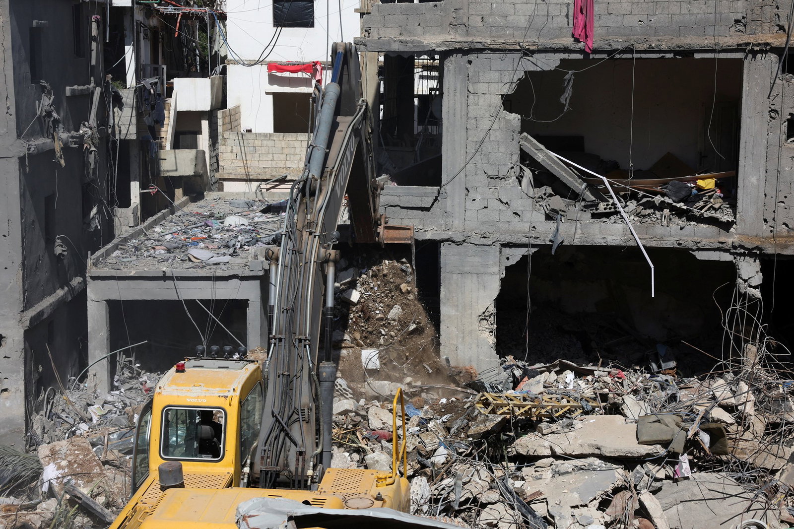 Machinery moves building debris. 