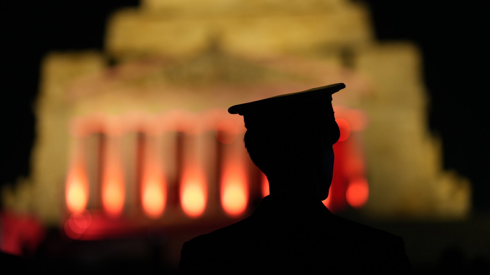 an abstract photo of a solder in front of a memorial
