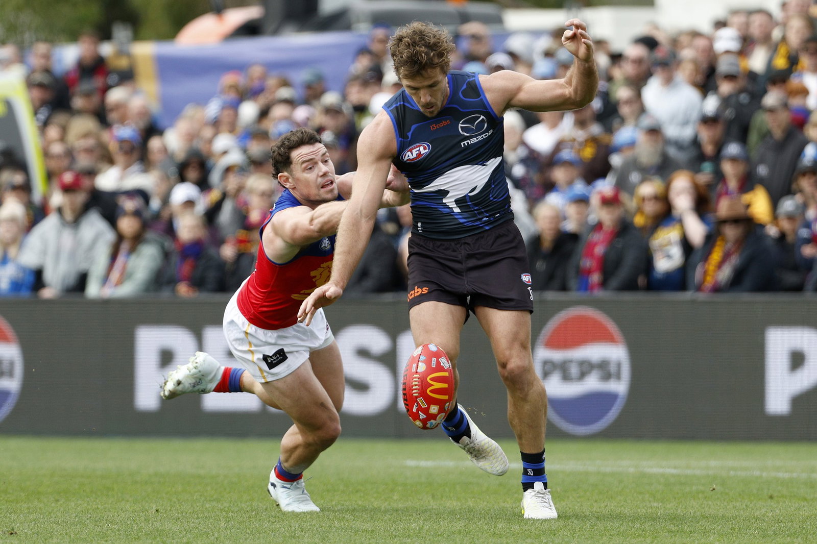 Luke Parker kicks the ball against the Lions.