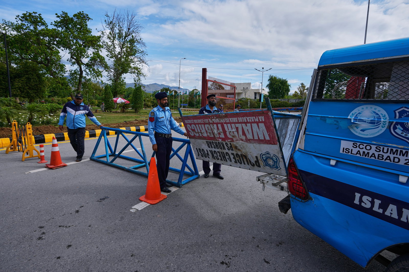 Police officers prepare to barricade a road