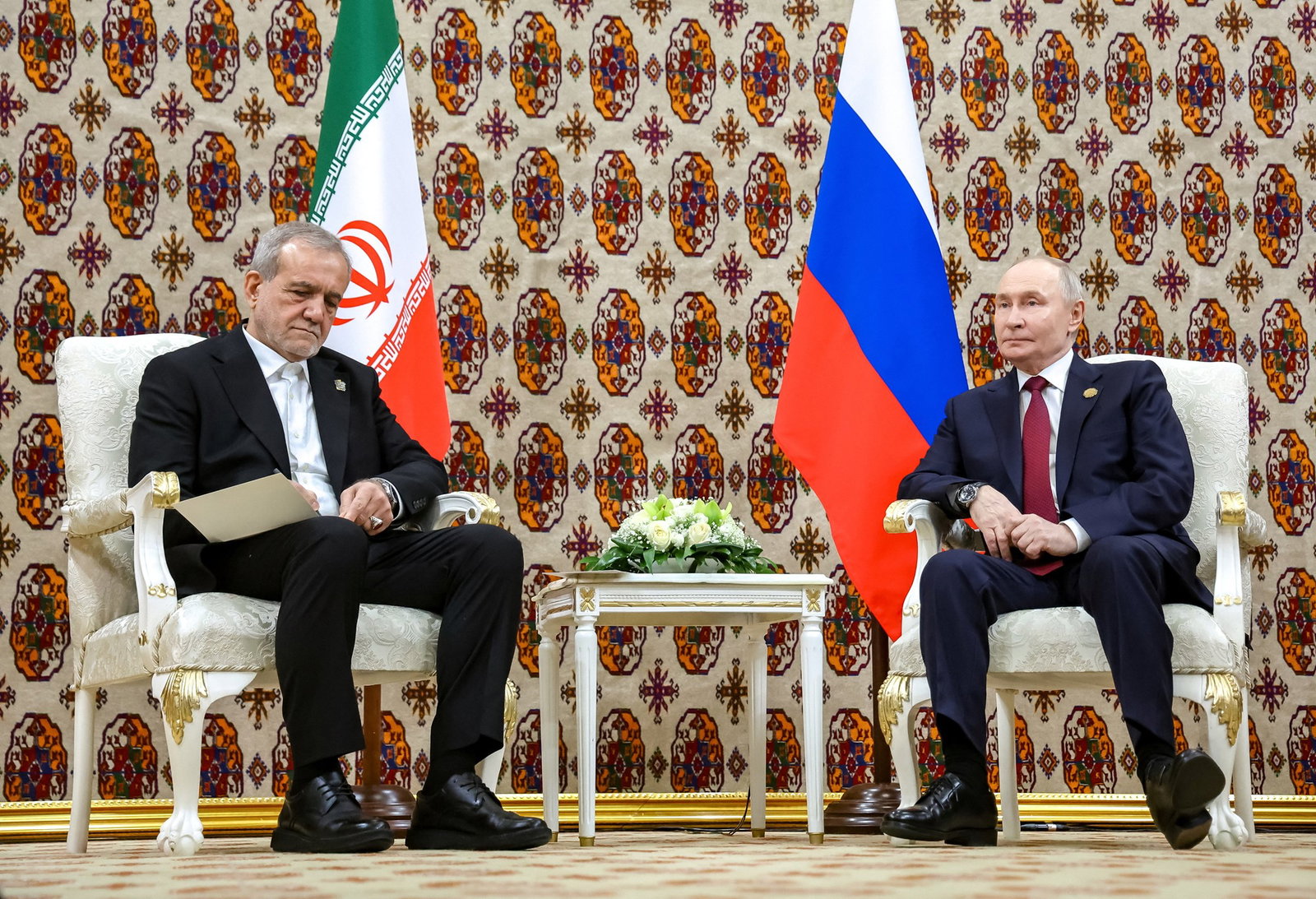 Russian President Vladimir Putin and Iranian President Masoud Pezeshkian attend a meeting 