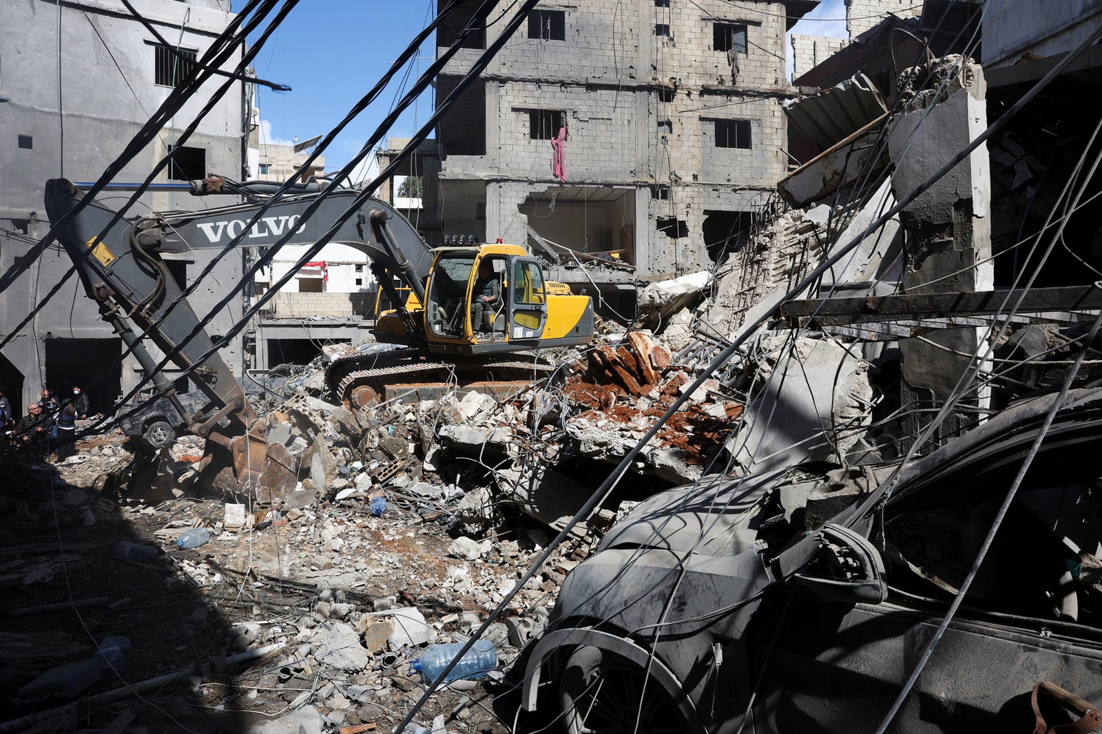 Machinery moves building debris. 