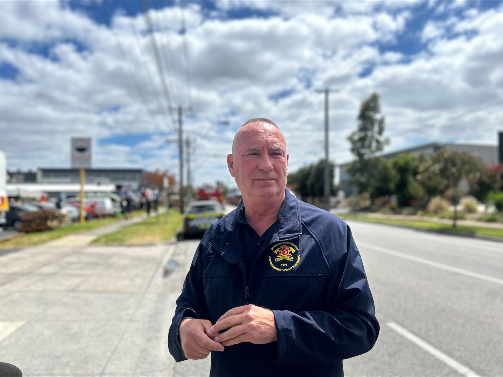 United Firefighters Union secretary Peter Marshall poses on a suburban road.