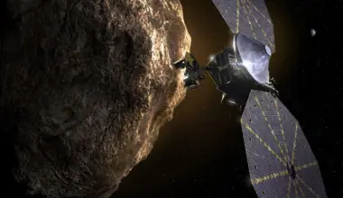 Concept art of Lucy visiting a Trojan asteroid. Credit - NASA / Goddard Spaceflight Center / SwRI