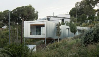 metallic house 144º rises on steel stilts above barcelona hillside