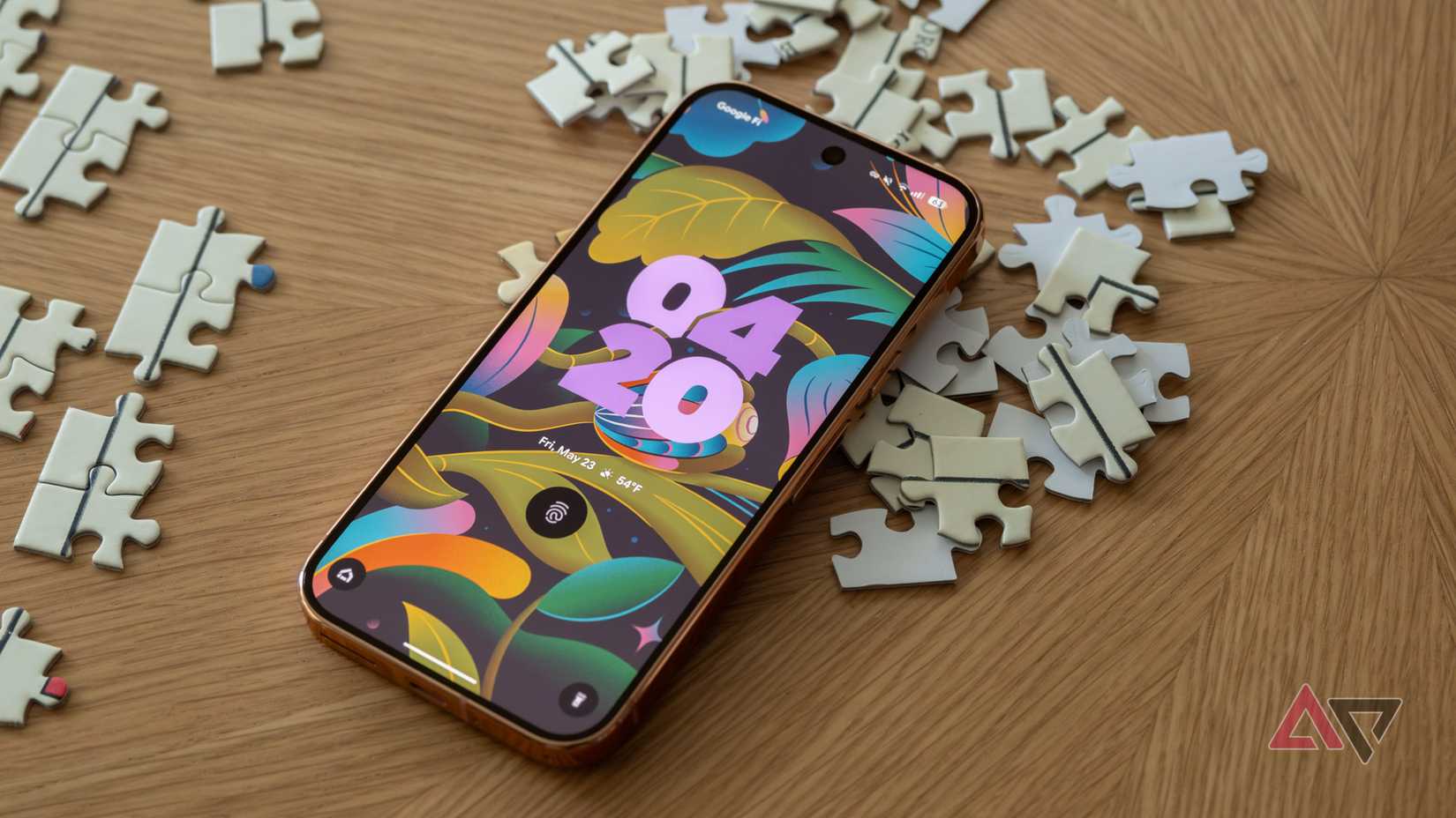 A Pixel 9 Pro sitting face-up on top of puzzle pieces