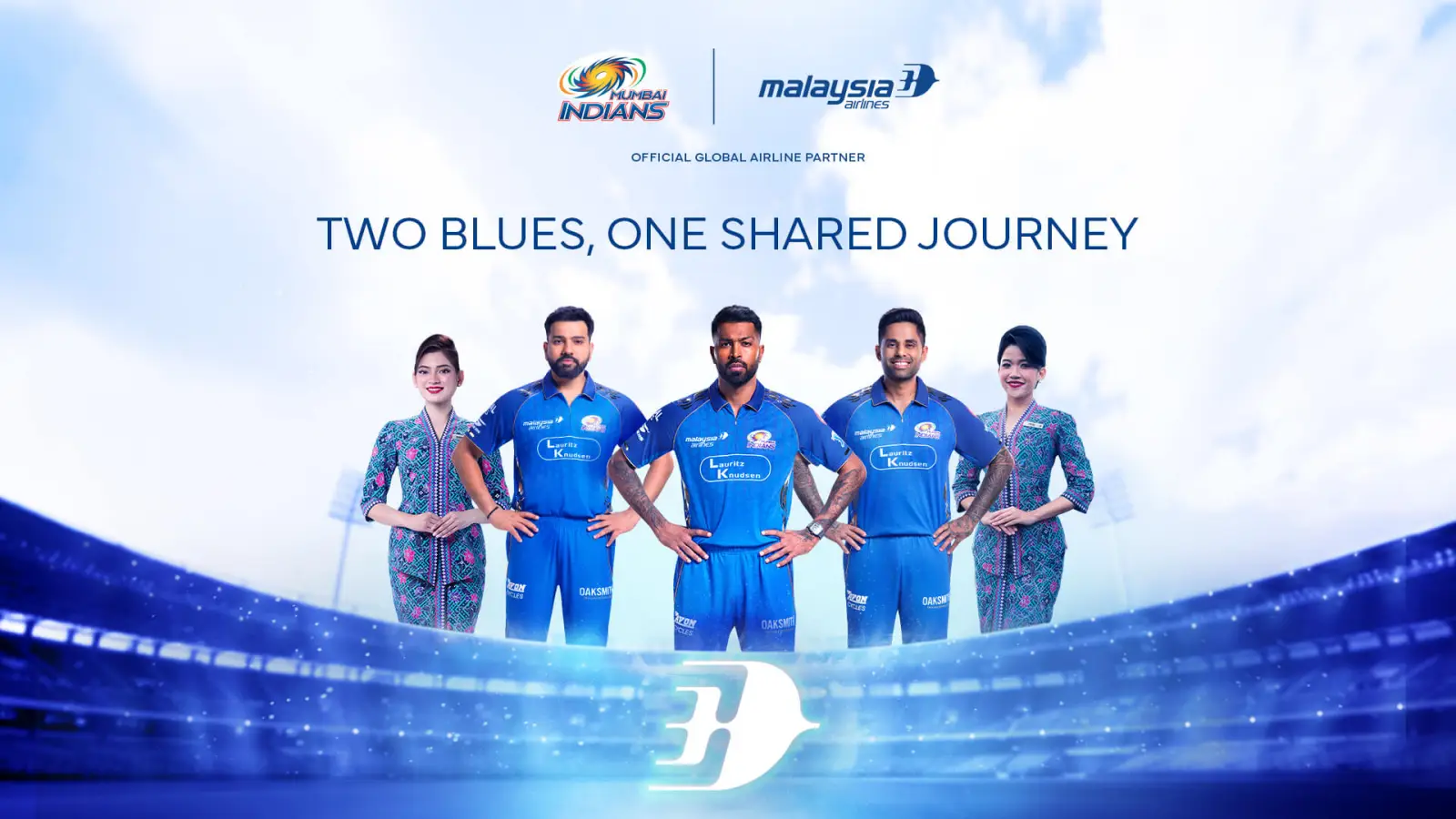 Malaysia Airlines Unveils Mumbai Indians’ Cricket-Themed Aircraft 3 Mumbai Indians cricket players and Malaysia Airlines cabin crew in uniforms posing together in stadium setting under “Two Blues, One Shared Journey” campaign