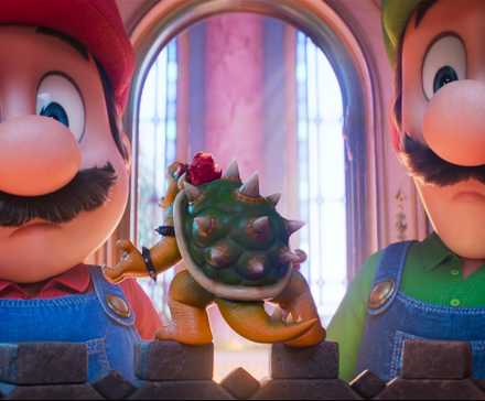 Mario and Luigi look down at miniature Bowser in a still from The Super Mario Galaxy Movie
