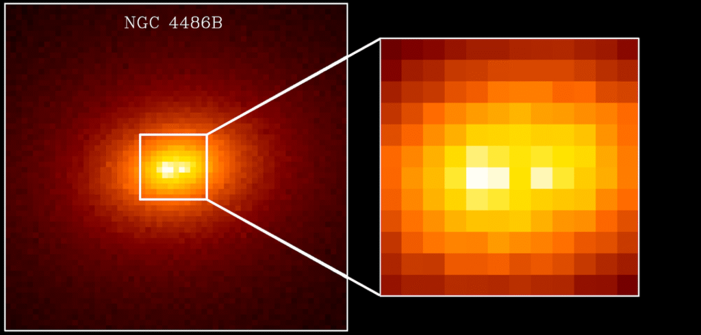 A Hubble Telescope image is colored like a heatmap to show the brightness regions of the galaxy NGC 4486B. Most galaxies would have a central white hot spot, but NGC 4486B has two close together.