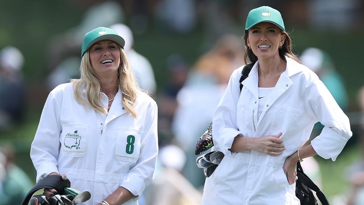 Nicole Willett and Paulina Gretzky watching the Par Three Contest at Augusta National Golf Club