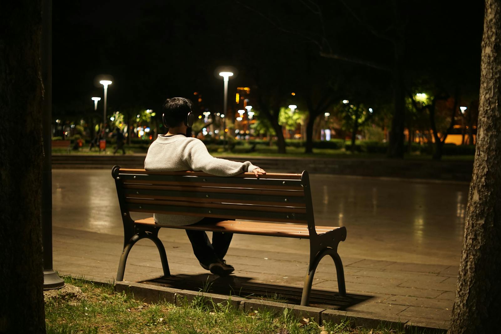 person sitting alone park bench