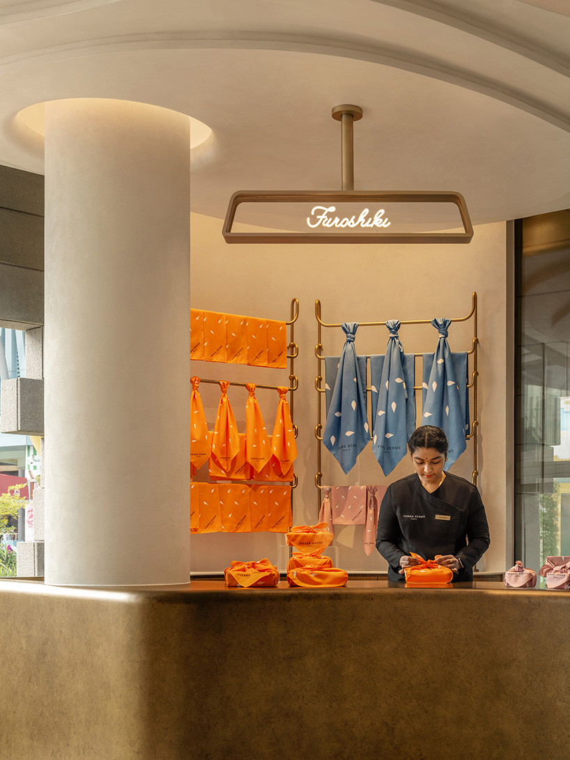 curved wood, rattan, and macaron displays frame a tropical french pâtisserie in singapore - 7