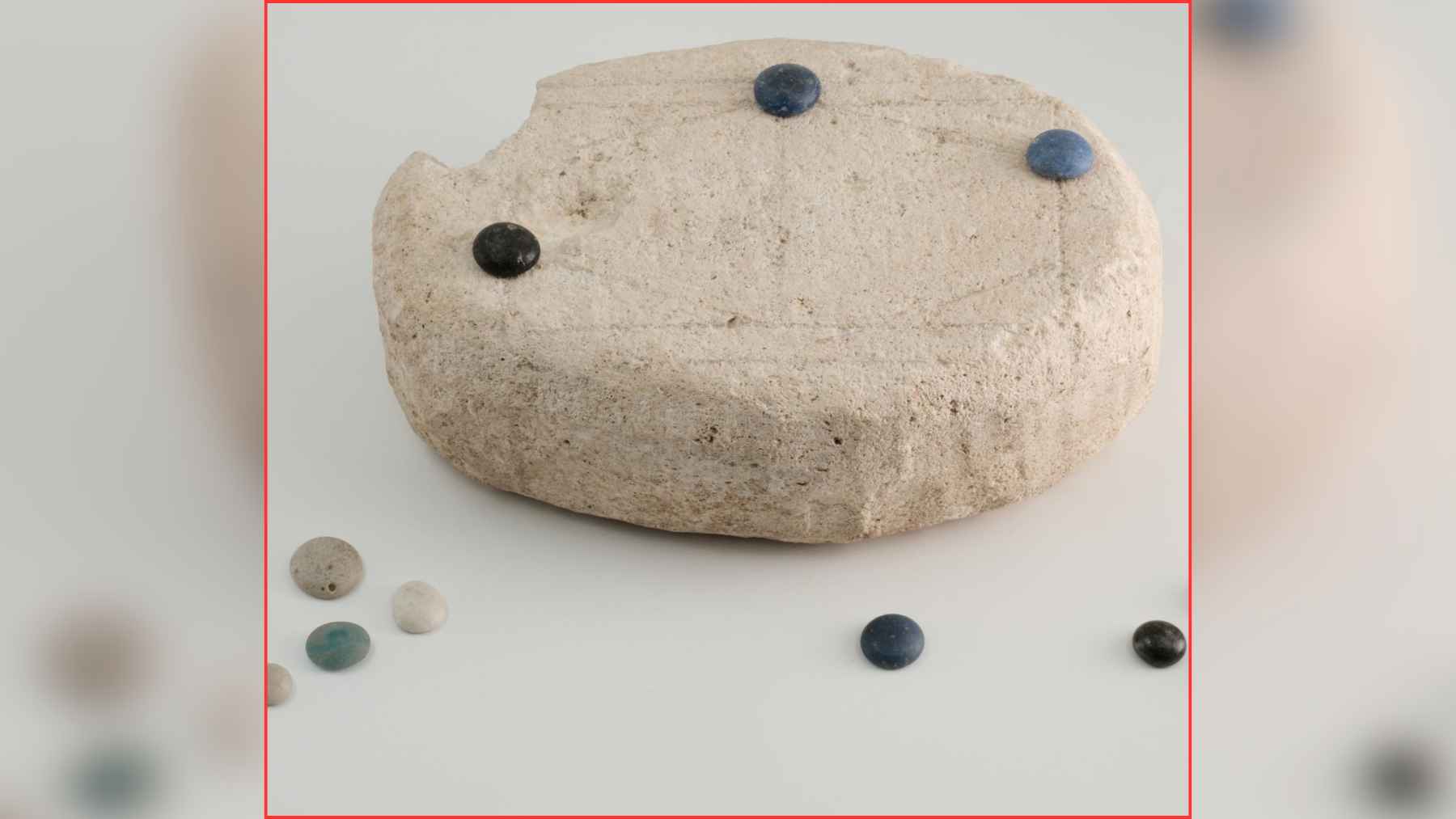 Ancient Roman stone object with playing pieces, identified by researchers as a possible board game through AI analysis