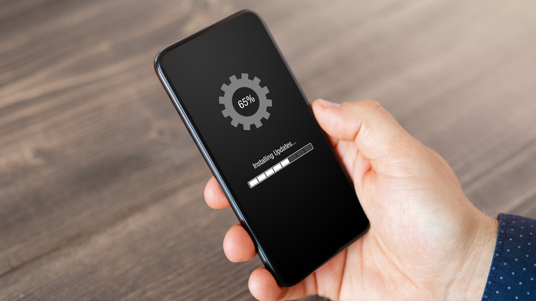 Person updating a smartphone