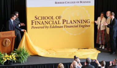 Speakers at the event unveil the new banner of the School of Financial Planning, powered by Edelman Financial Engines.