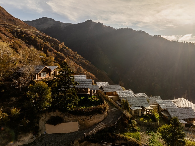 reclaimed timber reassembles a cluster of cabins into a mountain resort in china - 2