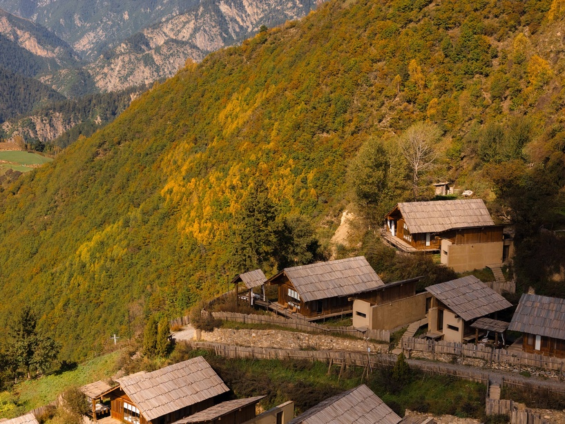 reclaimed timber reassembles a cluster of cabins into a mountain resort in china - 3