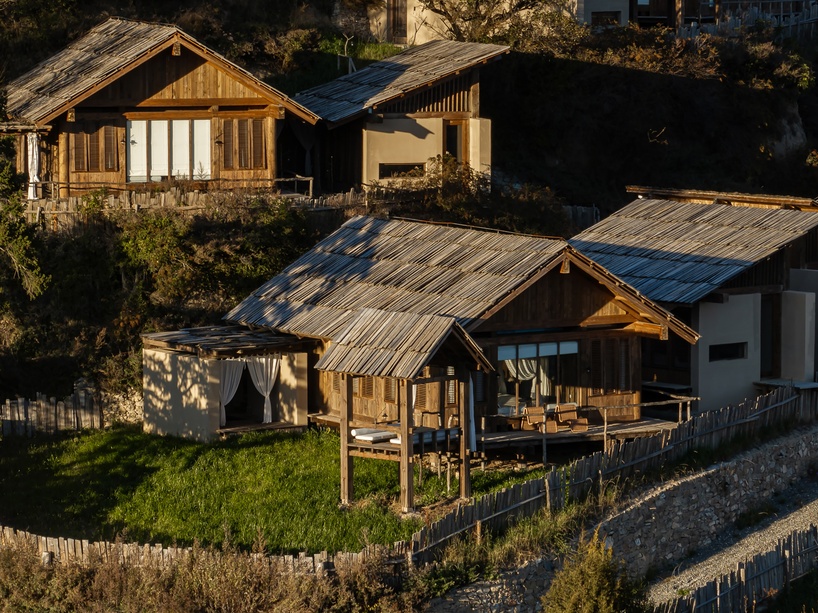 reclaimed timber reassembles a cluster of cabins into a mountain resort in china - 4