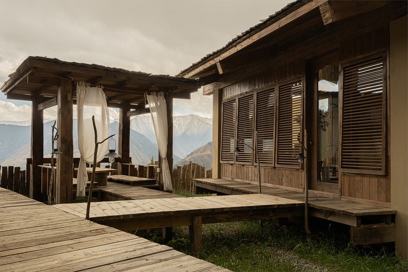 reclaimed timber reassembles a cluster of cabins into a mountain resort in china - 5