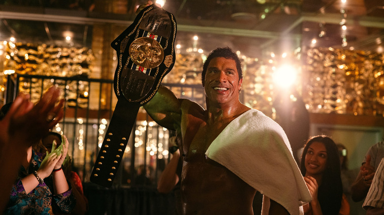 Mark Kerr holds a belt aloft in 