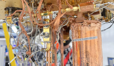 Setup of an experiment at Fermilab to test use of an ultrasensitive detector to search for evidence of dark photons, a hypothetical particle of dark matter. Housed within a dilution refrigerator kept at cryogenic temperatures, the copper wrapped mu-metal can, at right, contains the detector. Credit: Fang Zhao, Fermilab