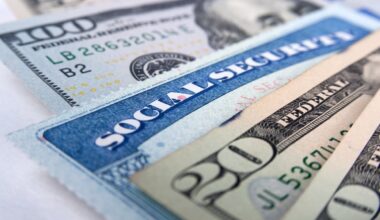 A Social Security card inserted between U.S. currency notes.
