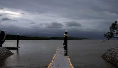 Grey storm clouds above a body of water.