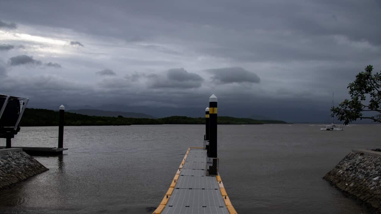 Grey storm clouds above a body of water.